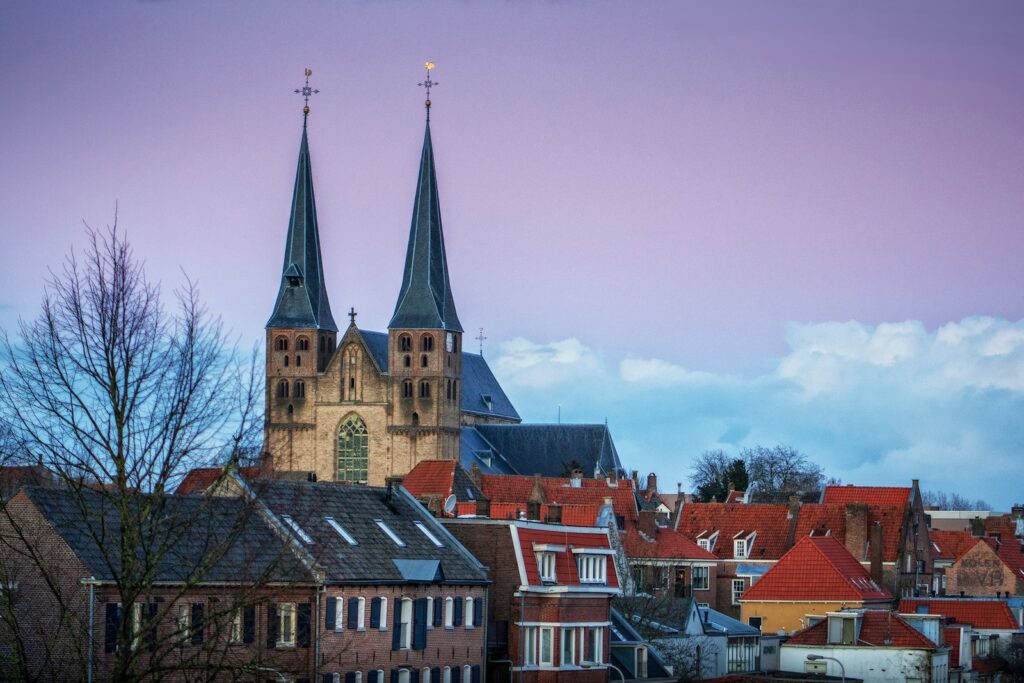 a view of a city with a church steeple in the background